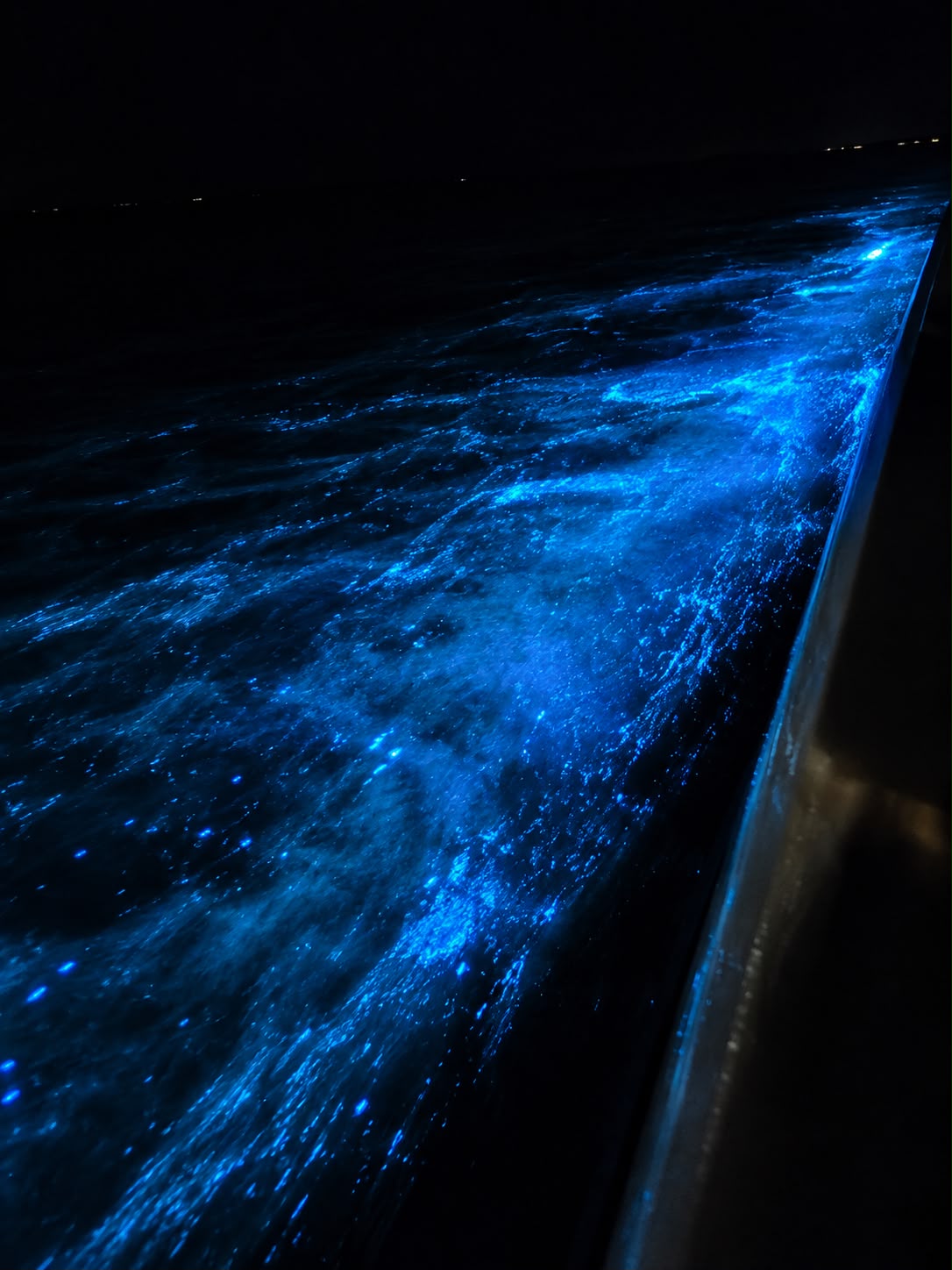 Blue light shimmering across moving seawater